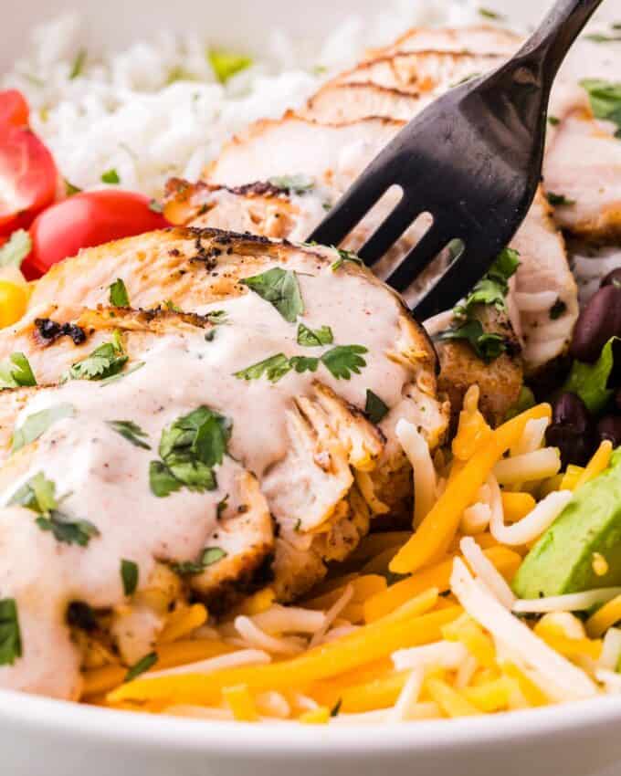 forkful of grilled chicken with chipotle lime crema