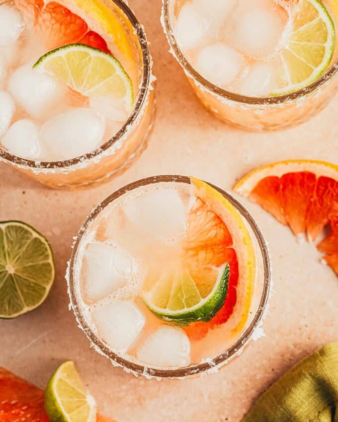 overhead photo of three glasses of grapefruit tequila cocktail.
