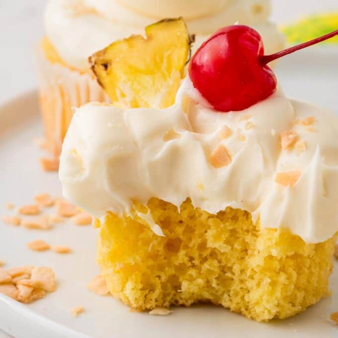 pina colada cupcake with bite taken out of it