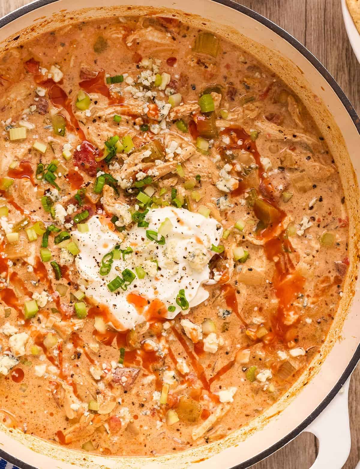 This version of chicken chili combines the flavors of creamy white chicken chili with classic buffalo chicken! Made easily on the stovetop, with no fancy equipment, it's perfect for game day, tailgating, or a comforting night in.