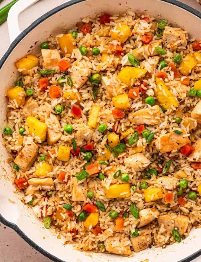 This takeout-style chicken and pineapple fried rice is packed with flavor, and on the table in 30 minutes or less! You'll love how easy this dinner recipe is to make and customize. It's great for meal prep as well!