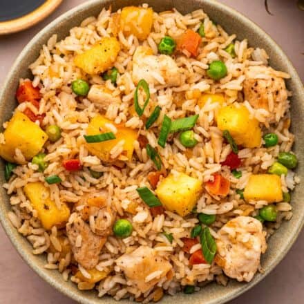 overhead photo of chicken fried rice with pineapple in a bowl.