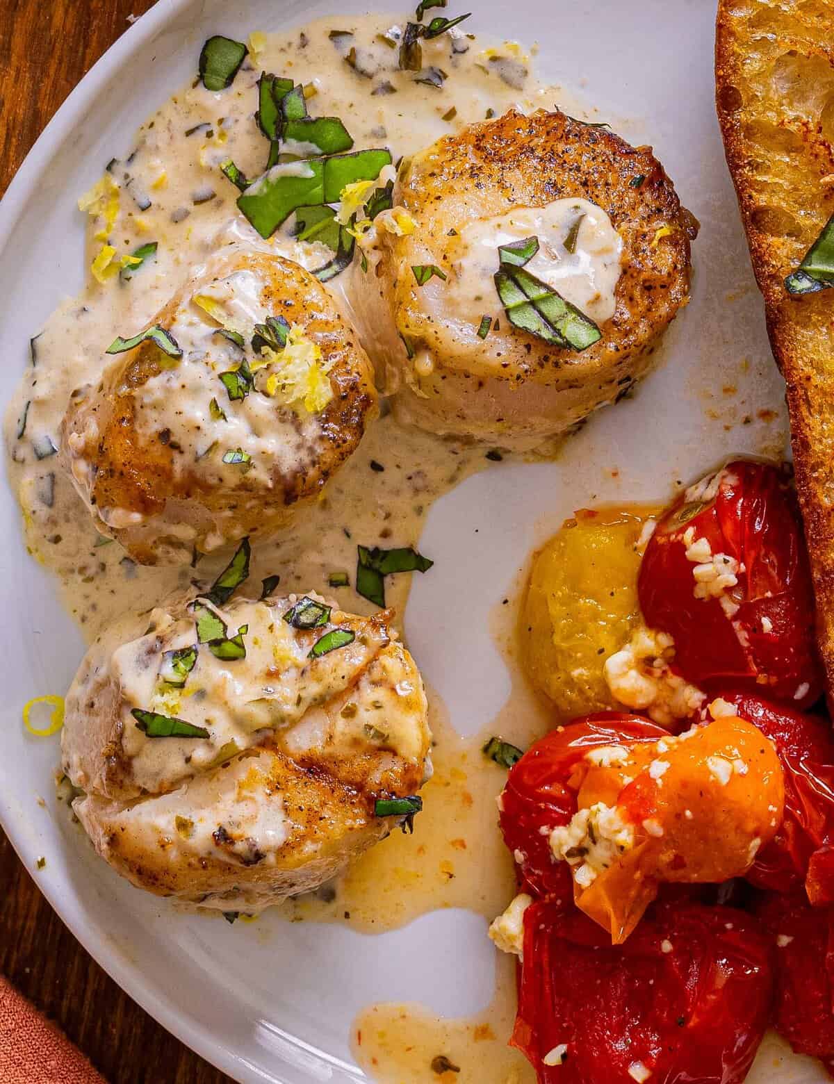 Simple and easy, this creamy pesto scallops recipe is made in one skillet, and ready in about 30-40 minutes! Succulent sea scallops are seared and nestled into a creamy pesto sauce that's packed with bold savory flavors... it's a perfect weeknight dinner idea!