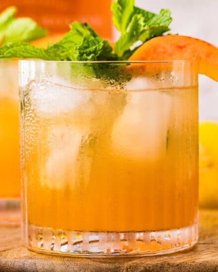This cocktail is the perfect blend of sweet and tart, with an earthy bourbon kick! The peaches add an amazing sweetness, and the cinnamon peach syrup is great to make ahead. Single serving and large batch recipes included!