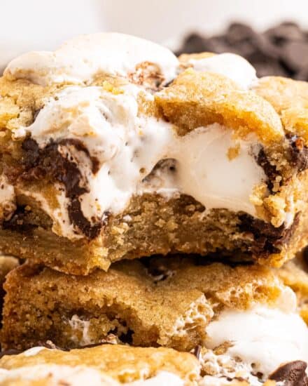 These s'mores chocolate chip cookie bars are chewy and soft, with a wonderfully ooey and gooey marshmallow layer in the middle, and crushed graham cracker crumbs in the cookie dough!