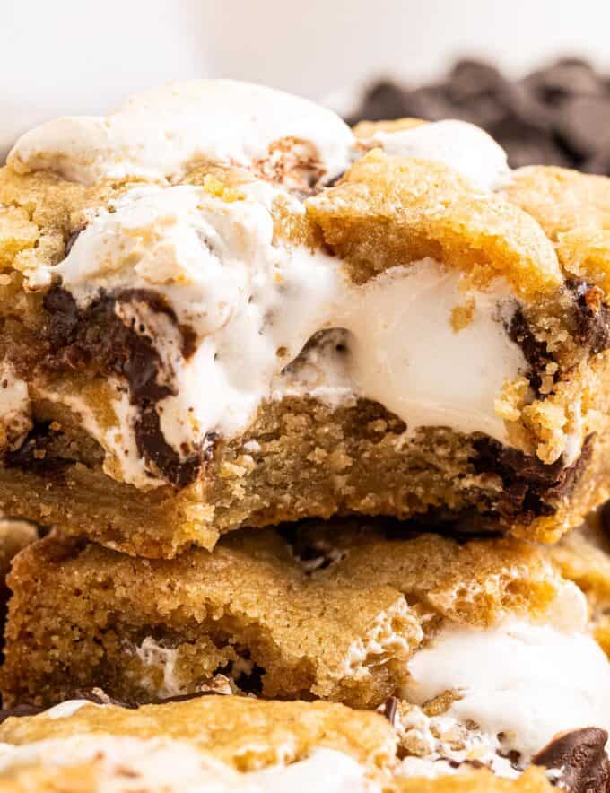 These s'mores chocolate chip cookie bars are chewy and soft, with a wonderfully ooey and gooey marshmallow layer in the middle, and crushed graham cracker crumbs in the cookie dough!