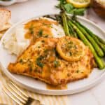 white plate with chicken francese, mashed potatoes, and asparagus