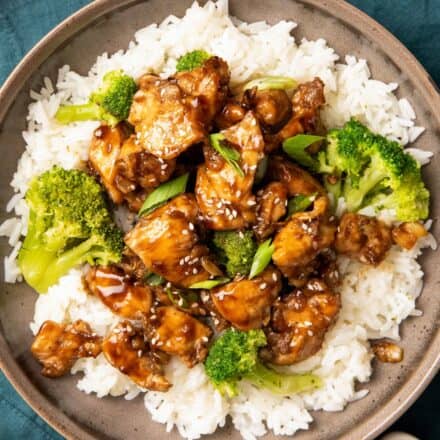 grey bowl filled with white rice, broccoli, and teriyaki chicken bites