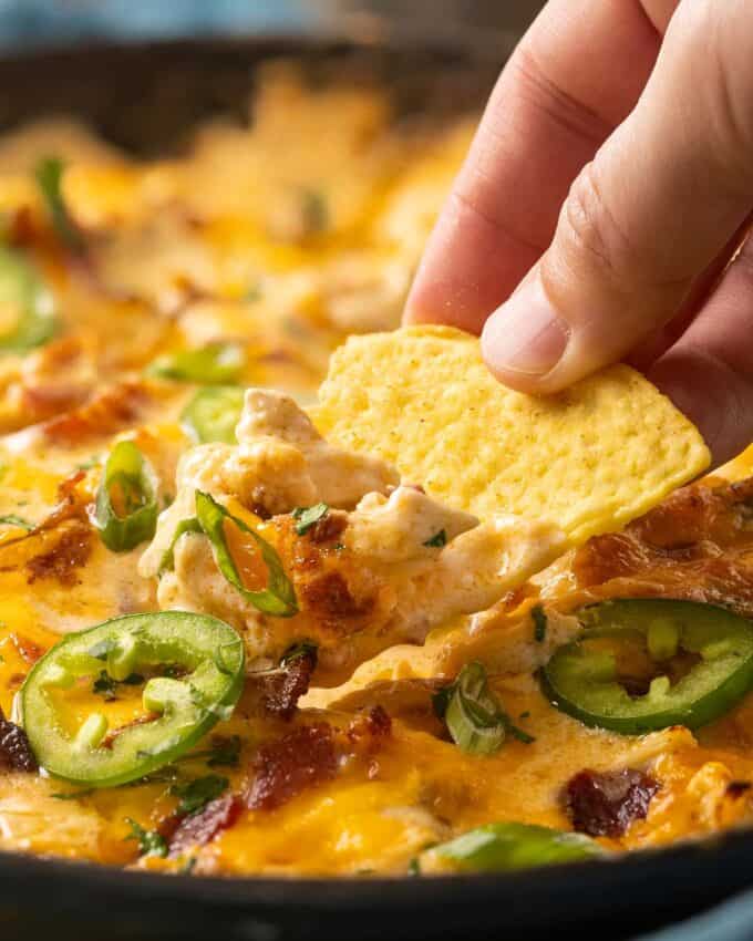 scoop of jalapeno popper dip with chicken on a chip