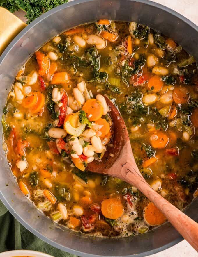 This hearty yet light tuscan white bean soup is a filling vegetarian meal that's easy to make in one pot on the stovetop! Easy to change up to your family's tastes, you'll love a big bowl of this comforting soup.