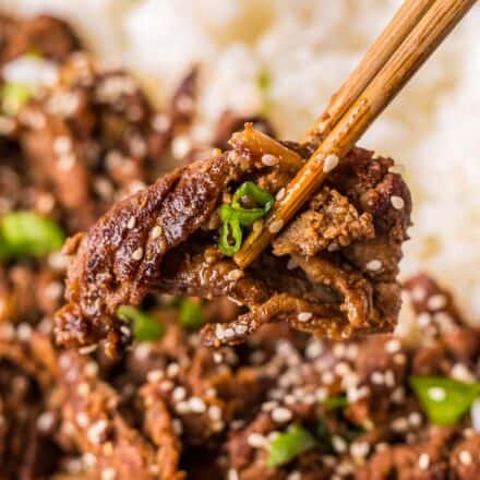 chopsticks holding a piece of beef bulgogi