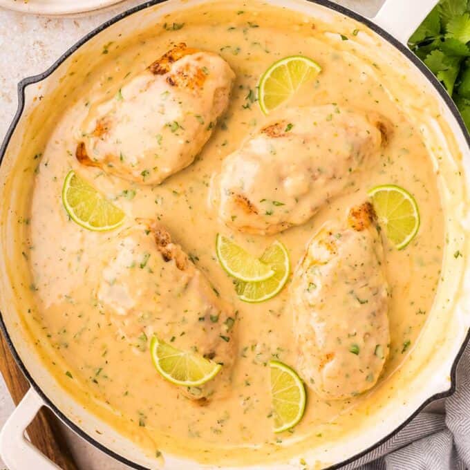 chicken breasts in a coconut lime sauce in a skillet