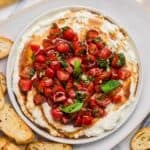 white bowl filled with whipped feta and bruschetta dip