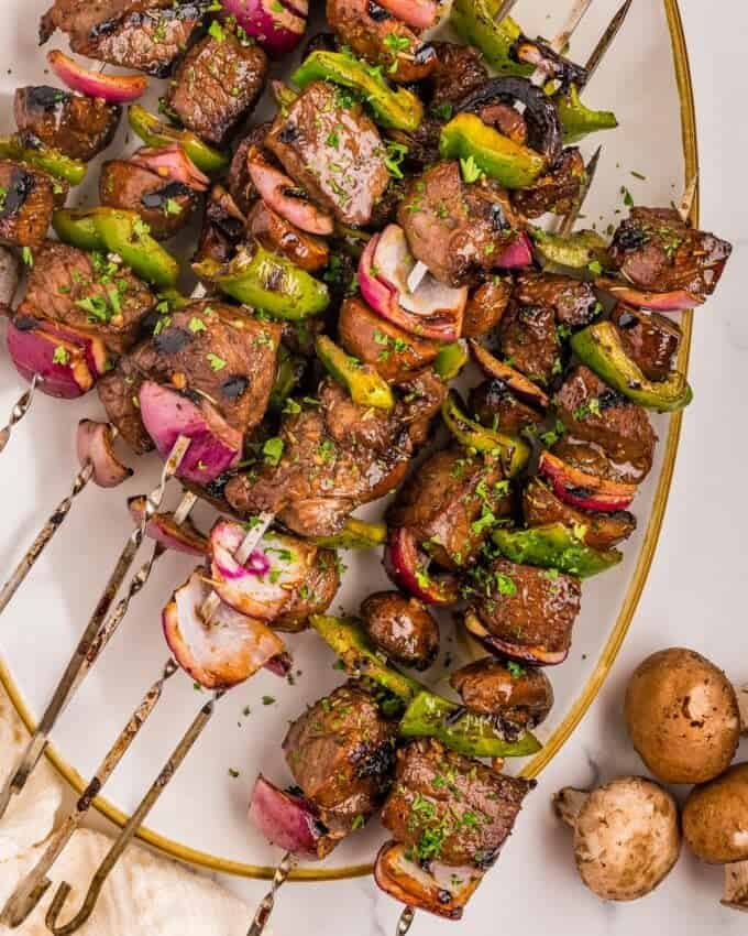 grilled steak skewers on a platter.