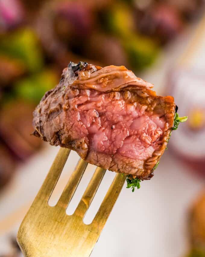 a bite of steak from the steak skewers