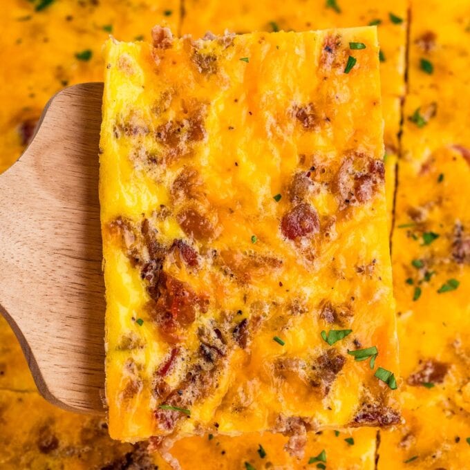 slice of sheet pan egg scramble on a wooden spatula