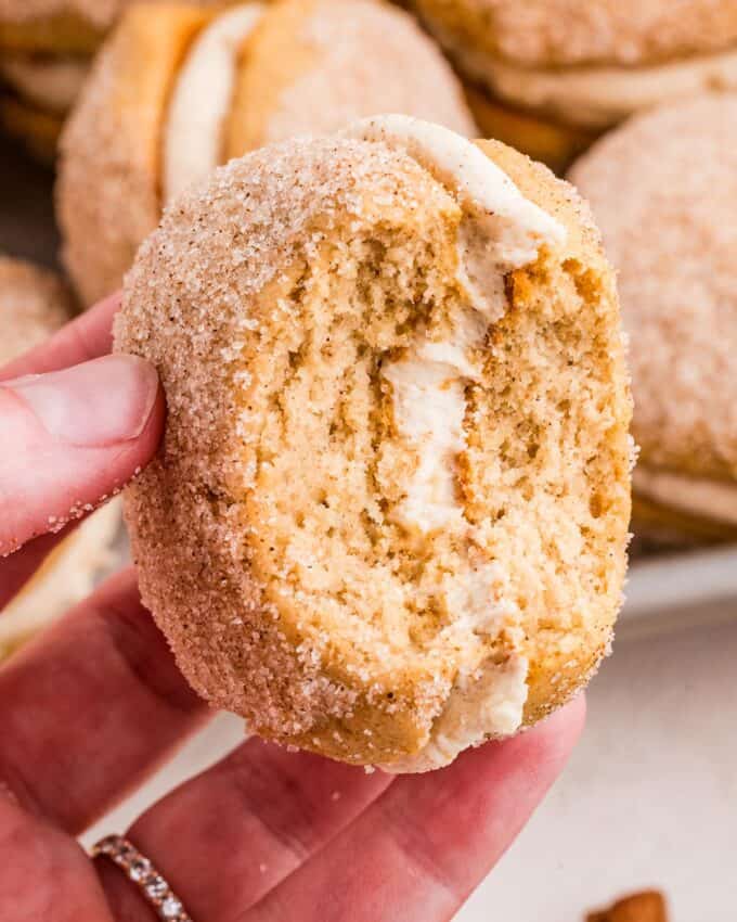 apple cider donut whoopie pie with a bite taken out of it