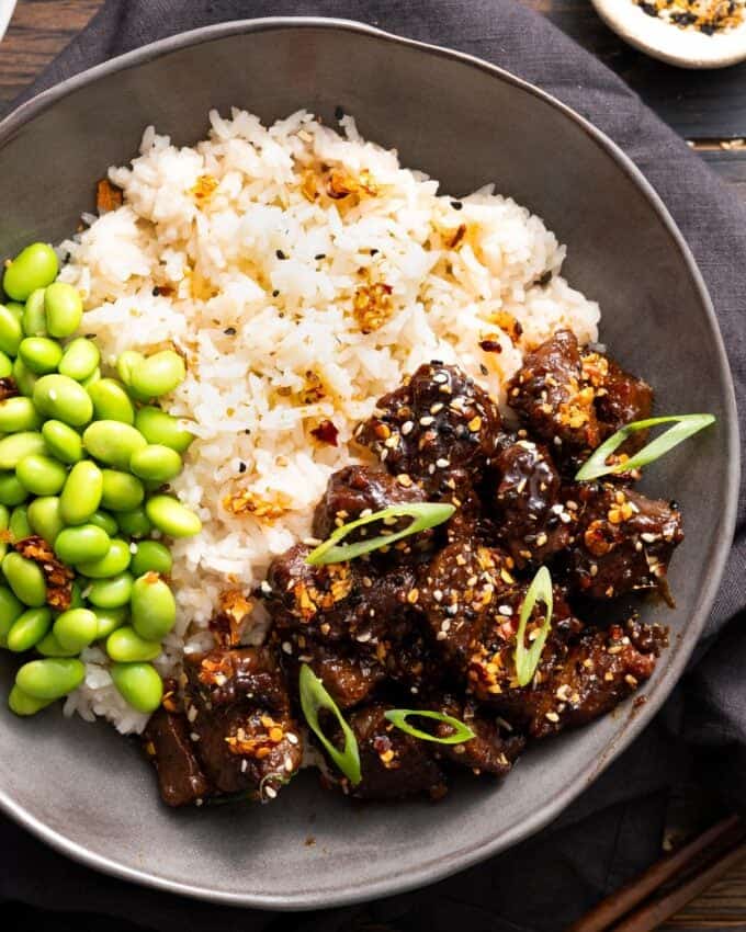 bowl filled with miso soy steak bites, rice, and edamame